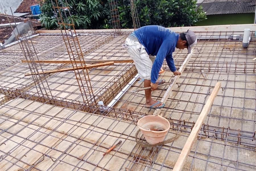 Construction Worker Preparing Rebar for Concrete Slab